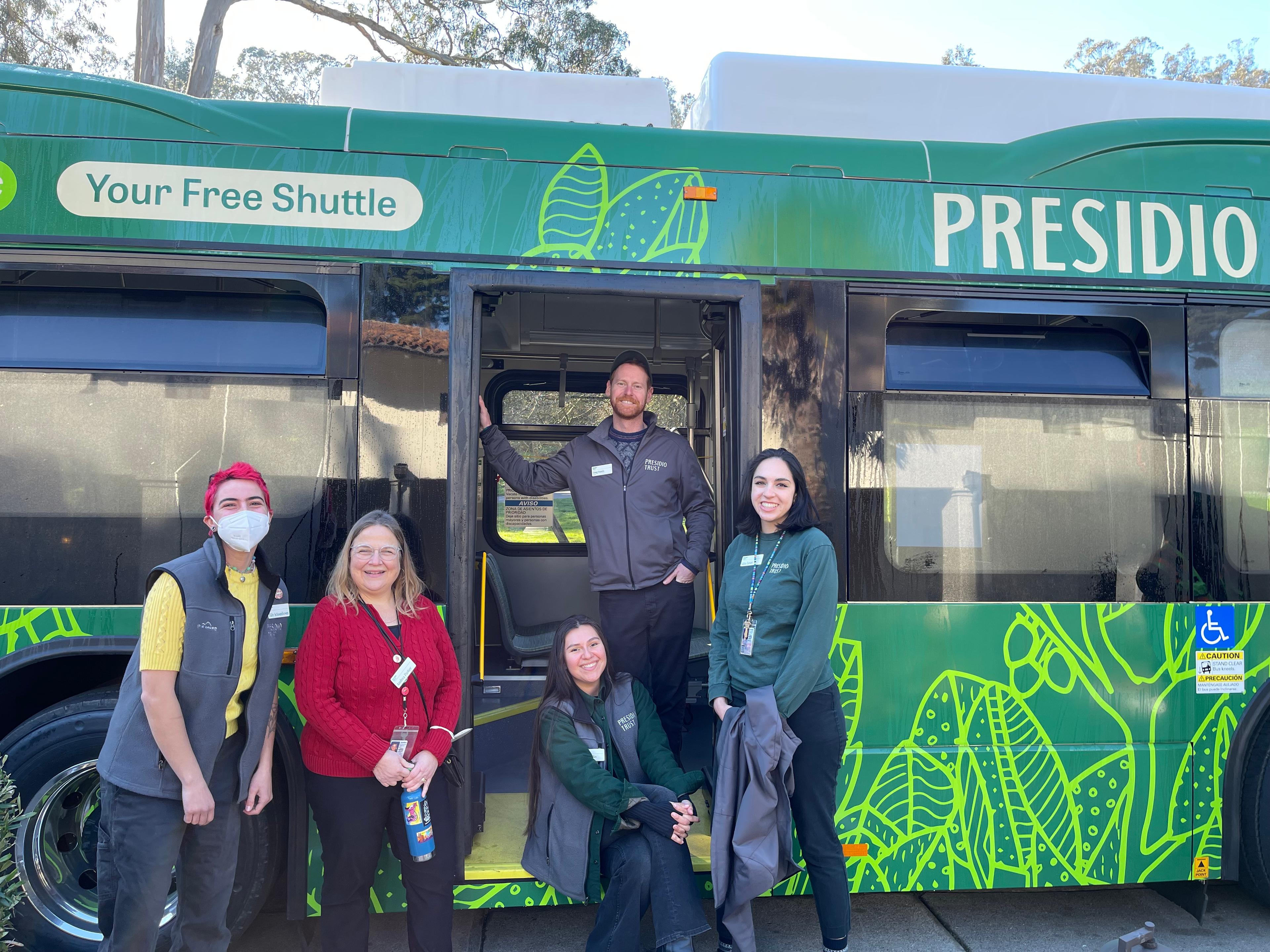 Several Presidio Trust staff members standing in front of a Presidio GO Shuttle.